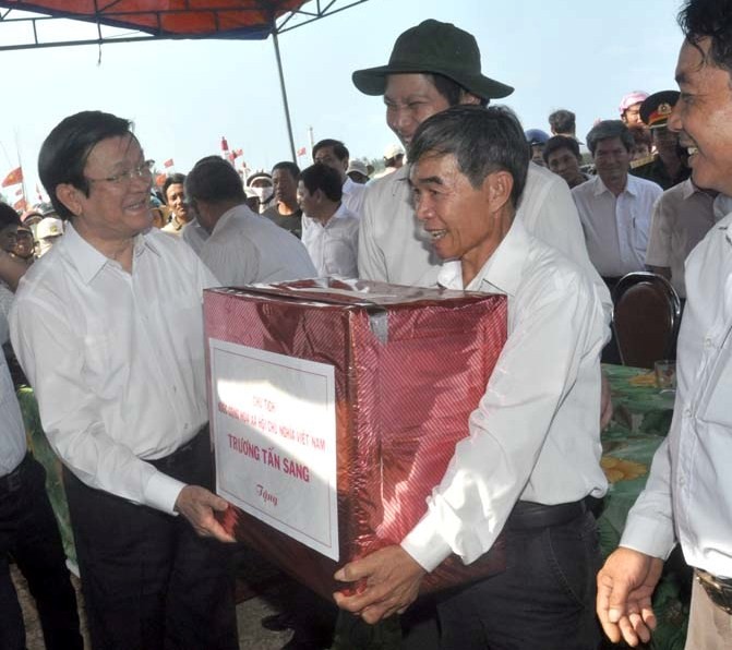 Ông Nguyễn Quốc Chinh đang nhận quà của Chủ tịch nước